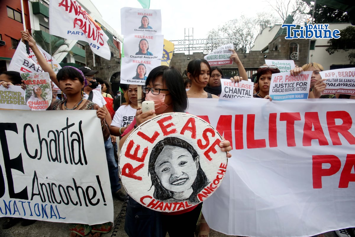 Human rights and migrant rights groups hold a protest outside Camp Aguinaldo in Quezon City on Monday, calling for the immediate release of Filipino-American activist Chantal Anicoche and condemning what they describe as her illegal detention following a reported encounter between government troops and the New People’s Army in Abra de Ilog, Occidental Mindoro, on 1 January.