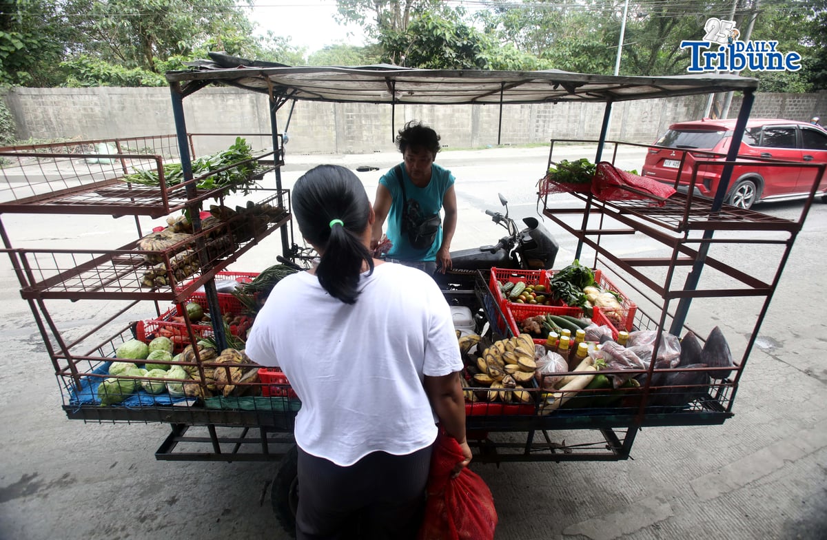 (January 15 2026) A man selling vegetables along Payatas road in Quezon City on 15 January 2026. he uses his tricycle to sell vegetables so they can go to another place. Photo/Analy Labor