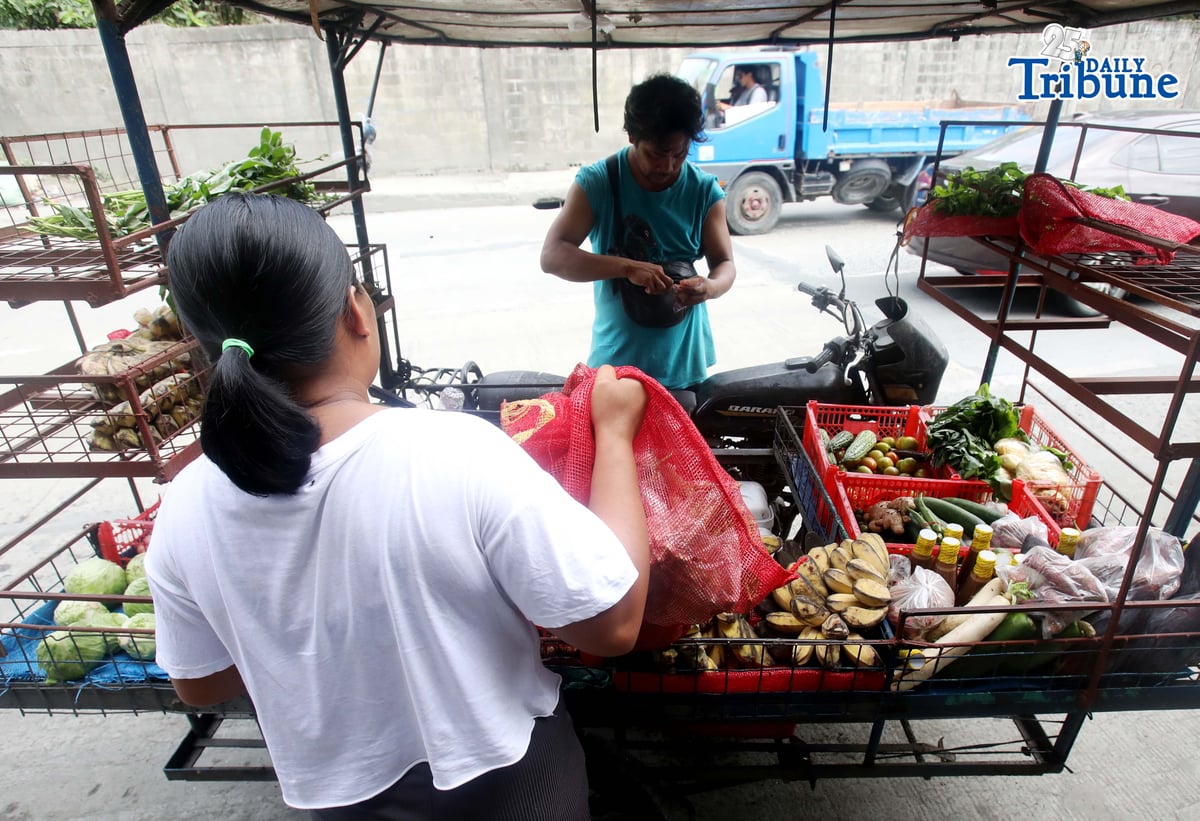 (January 15 2026) A man selling vegetables along Payatas road in Quezon City on 15 January 2026. he uses his tricycle to sell vegetables so they can go to another place. Photo/Analy Labor
