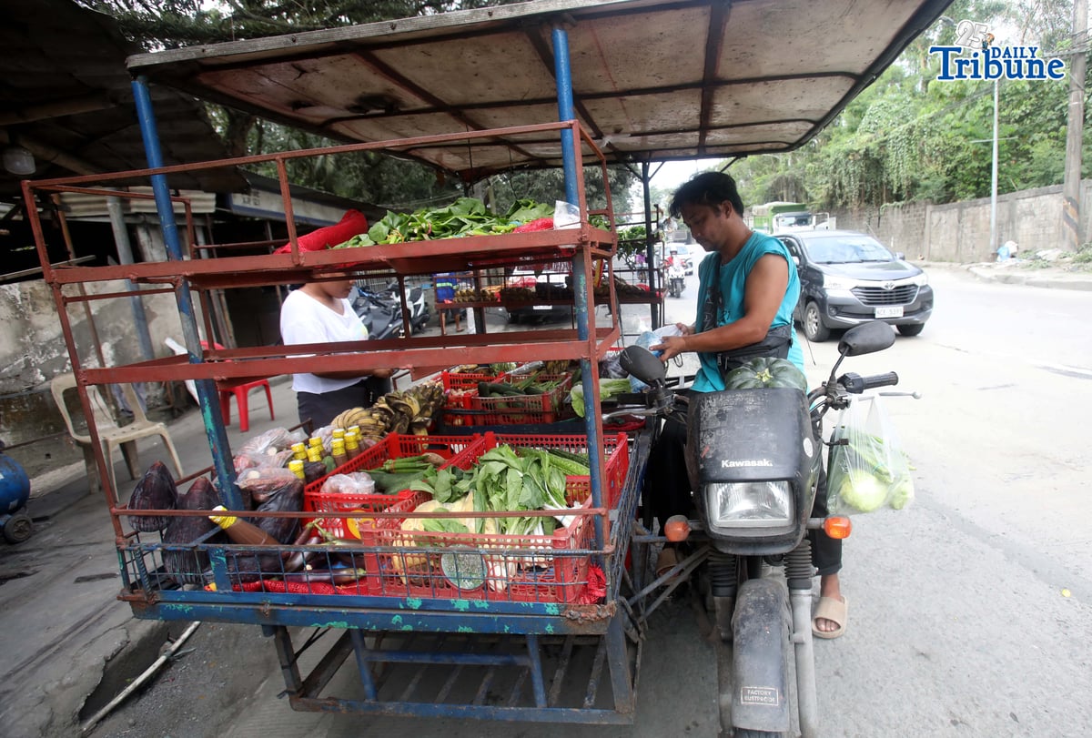 (January 15 2026) A man selling vegetables along Payatas road in Quezon City on 15 January 2026. he uses his tricycle to sell vegetables so they can go to another place. Photo/Analy Labor