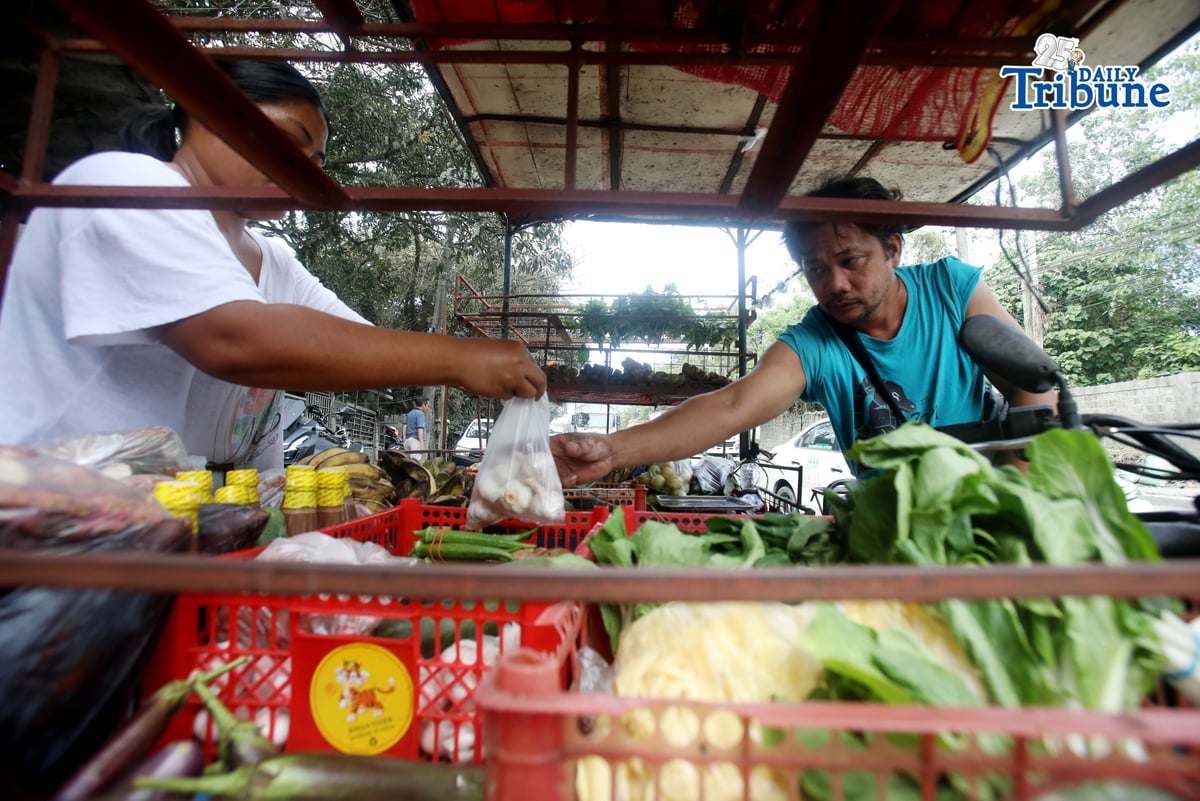 (January 15 2026) A man selling vegetables along Payatas road in Quezon City on 15 January 2026. he uses his tricycle to sell vegetables so they can go to another place. Photo/Analy Labor