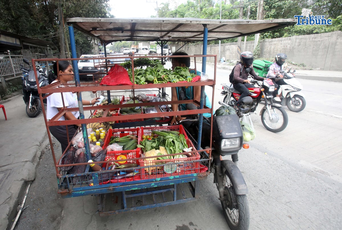 (January 15 2026) A man selling vegetables along Payatas road in Quezon City on 15 January 2026. he uses his tricycle to sell vegetables so they can go to another place. Photo/Analy Labor