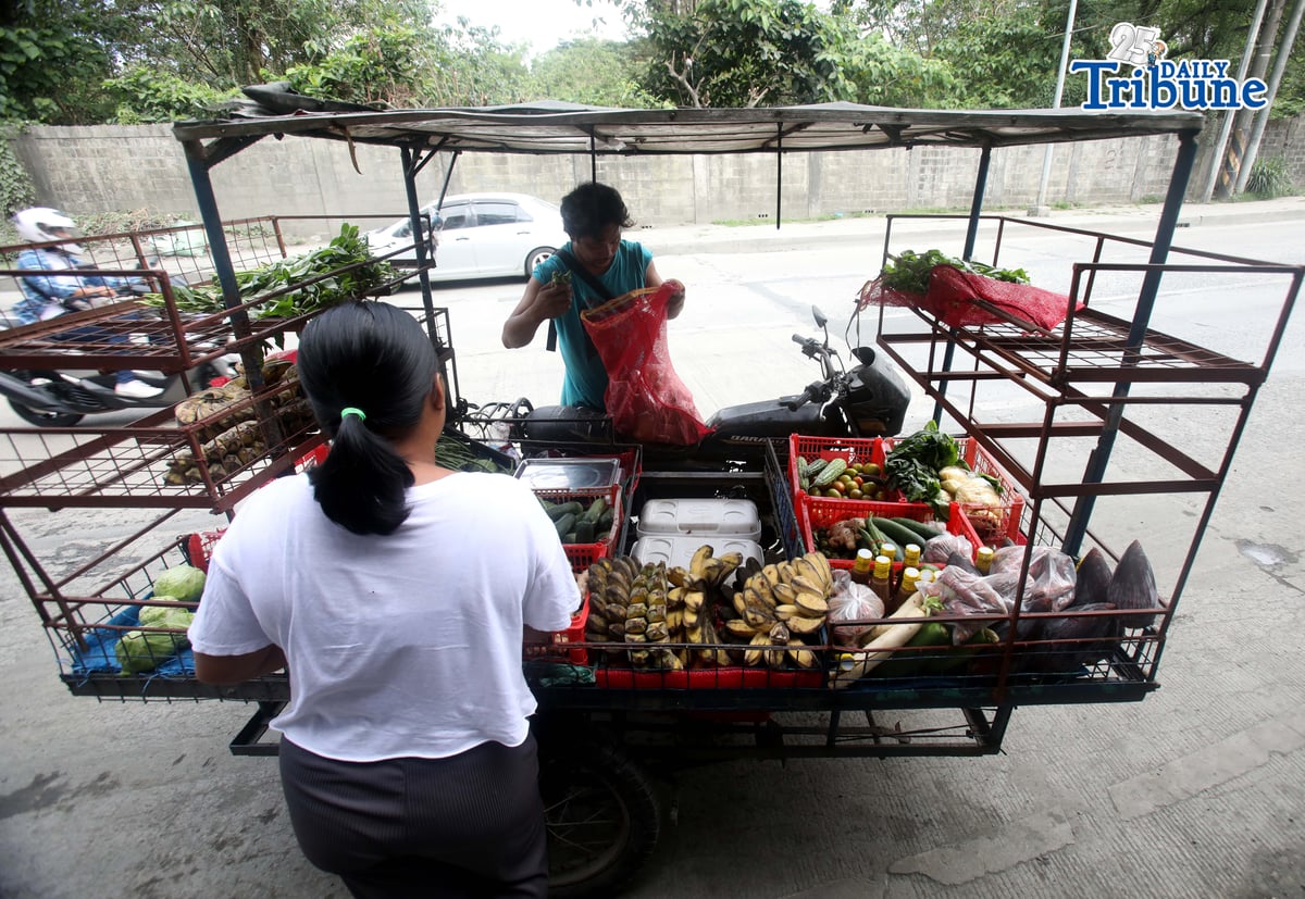 (January 15 2026) A man selling vegetables along Payatas road in Quezon City, he uses his tricycle to sell vegetables so they can go to another place. Photo/Analy Labor