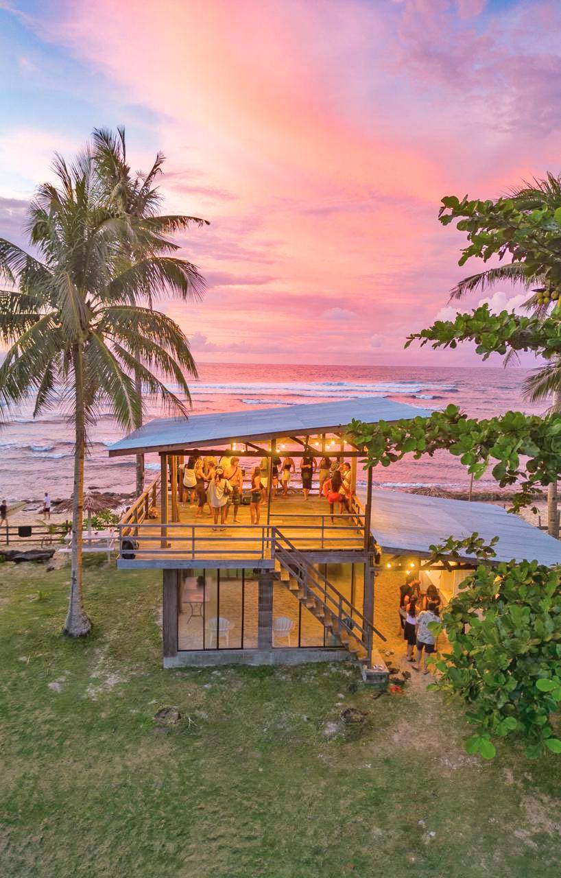 AS the sun dips over North Siargao, guests gather at the Ora sundeck, where vinyl sets, cold drinks, and ocean light ease the day into night.