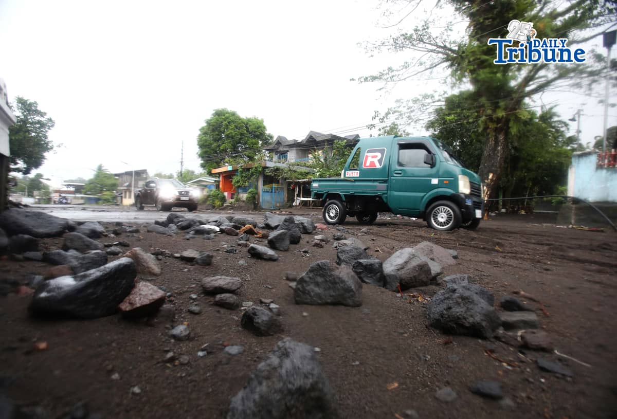 (January 17 2026) To help motorists passing through at the road in Brgy Masarawag, Guinobatan Albay, on Saturday January 17 2026, residents removed the sand and rocks scattered along the road because of flooding due to Tropical storm Ada on Saturday January 17 2026. Photo/Analy Labor
