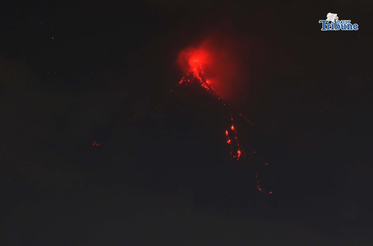 Pyroclastic density currents flow down the slopes of Mayon Volcano as seen from Legazpi City on Sunday night, 18 January 2026.