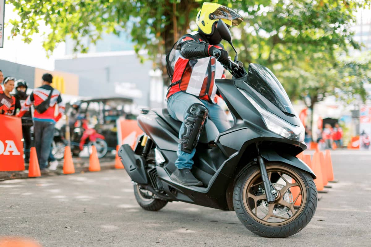 PARTICIPANTS navigate a cone course on a Honda scooter during a skills session held as part of the company’s rider engagement programs.
