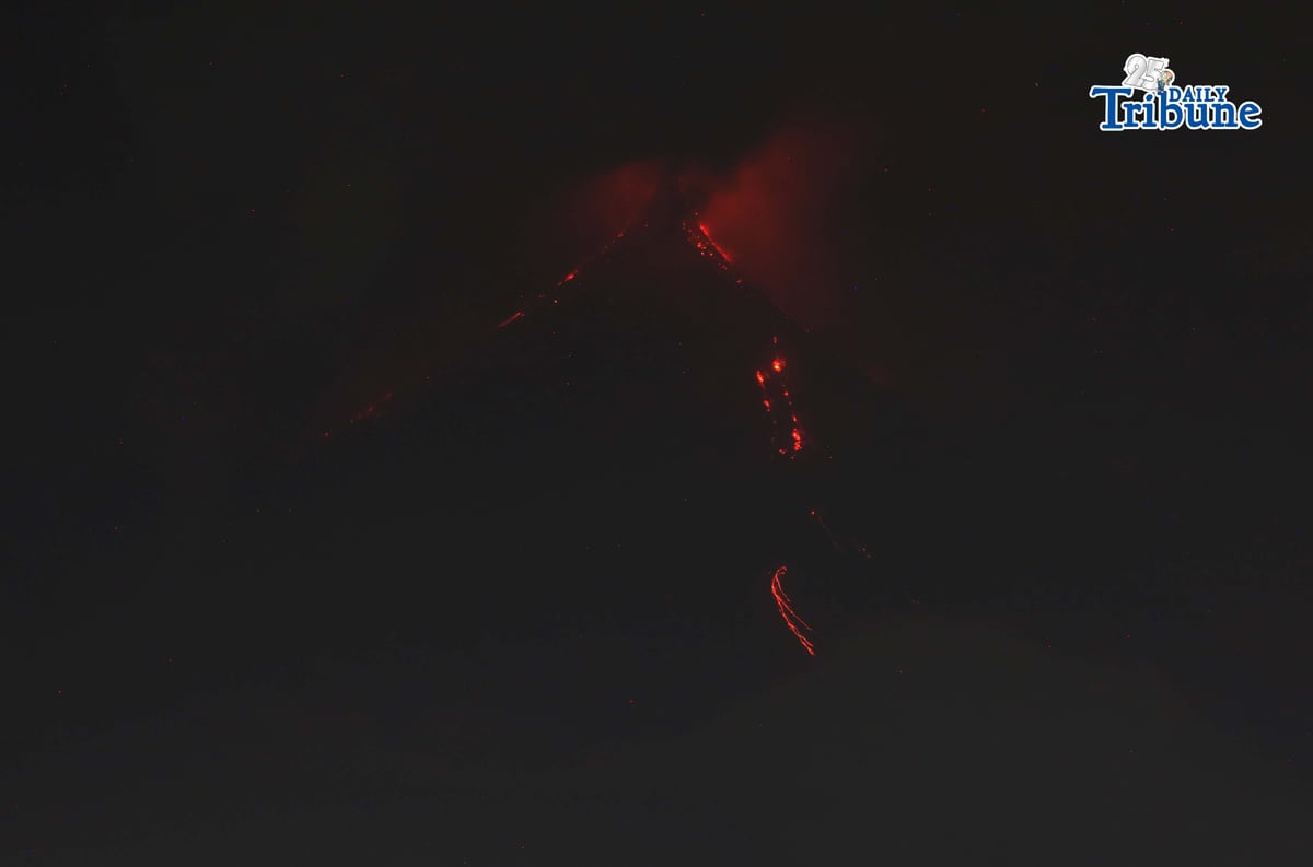 Pyroclastic density currents flow down the slopes of Mayon Volcano as seen from Legazpi City on Sunday night, 18 January 2026.