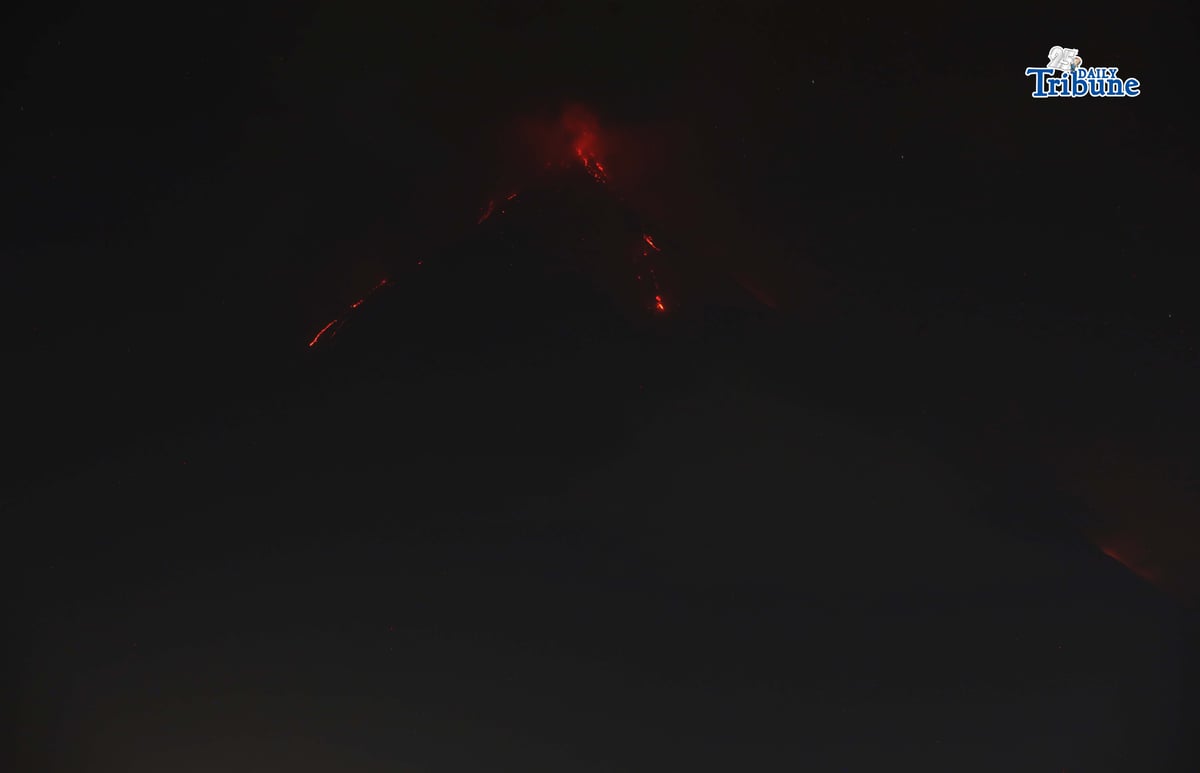 Pyroclastic density currents flow down the slopes of Mayon Volcano as seen from Legazpi City on Sunday night, 18 January 2026.