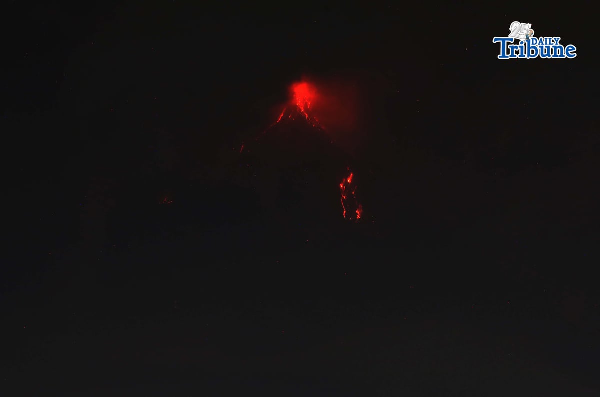 Pyroclastic density currents flow down the slopes of Mayon Volcano as seen from Legazpi City on Sunday night, 18 January 2026.