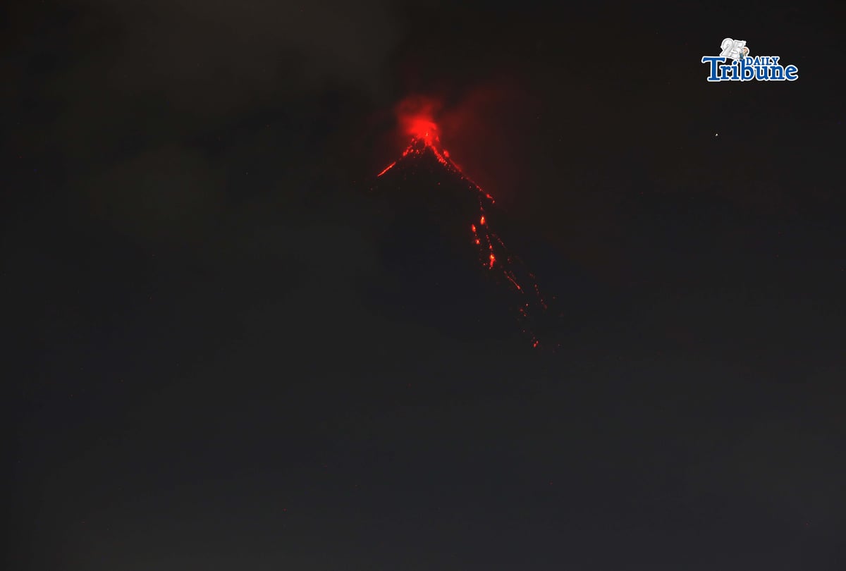 Pyroclastic density currents flow down the slopes of Mayon Volcano as seen from Legazpi City on Sunday night, 18 January 2026.