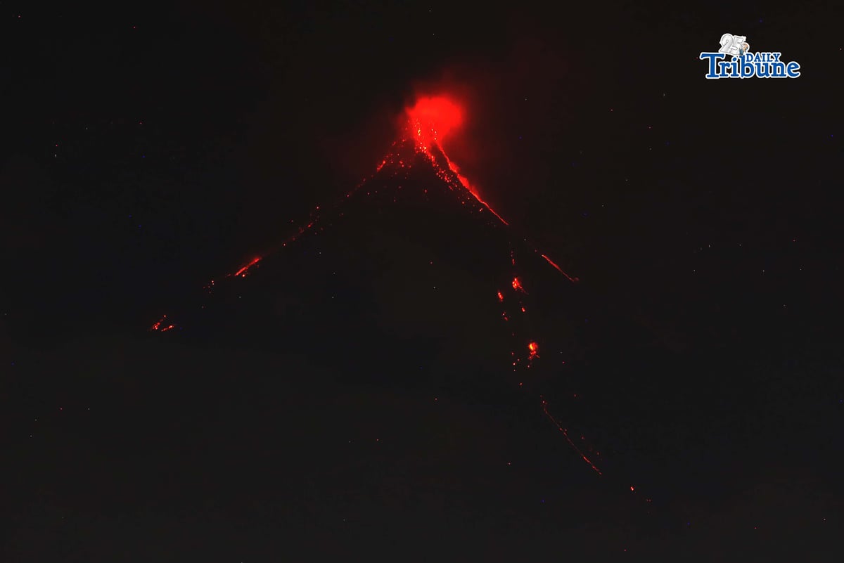 Pyroclastic density currents flow down the slopes of Mayon Volcano as seen from Legazpi City on Sunday night, 18 January 2026.