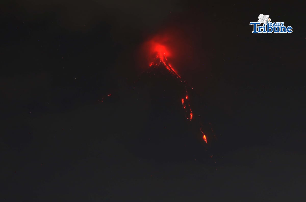 Pyroclastic density currents flow down the slopes of Mayon Volcano as seen from Legazpi City on Sunday night, 18 January 2026.
