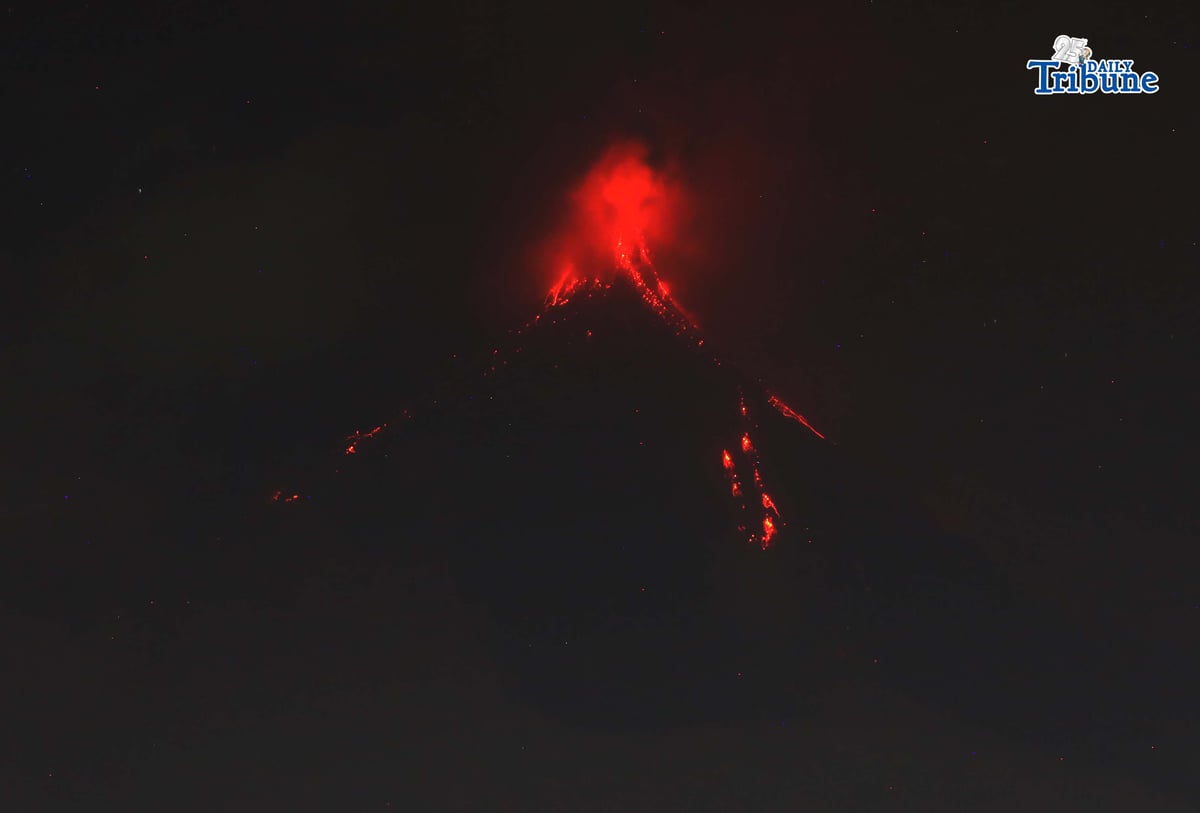 Pyroclastic density currents flow down the slopes of Mayon Volcano as seen from Legazpi City on Sunday night, 18 January 2026.