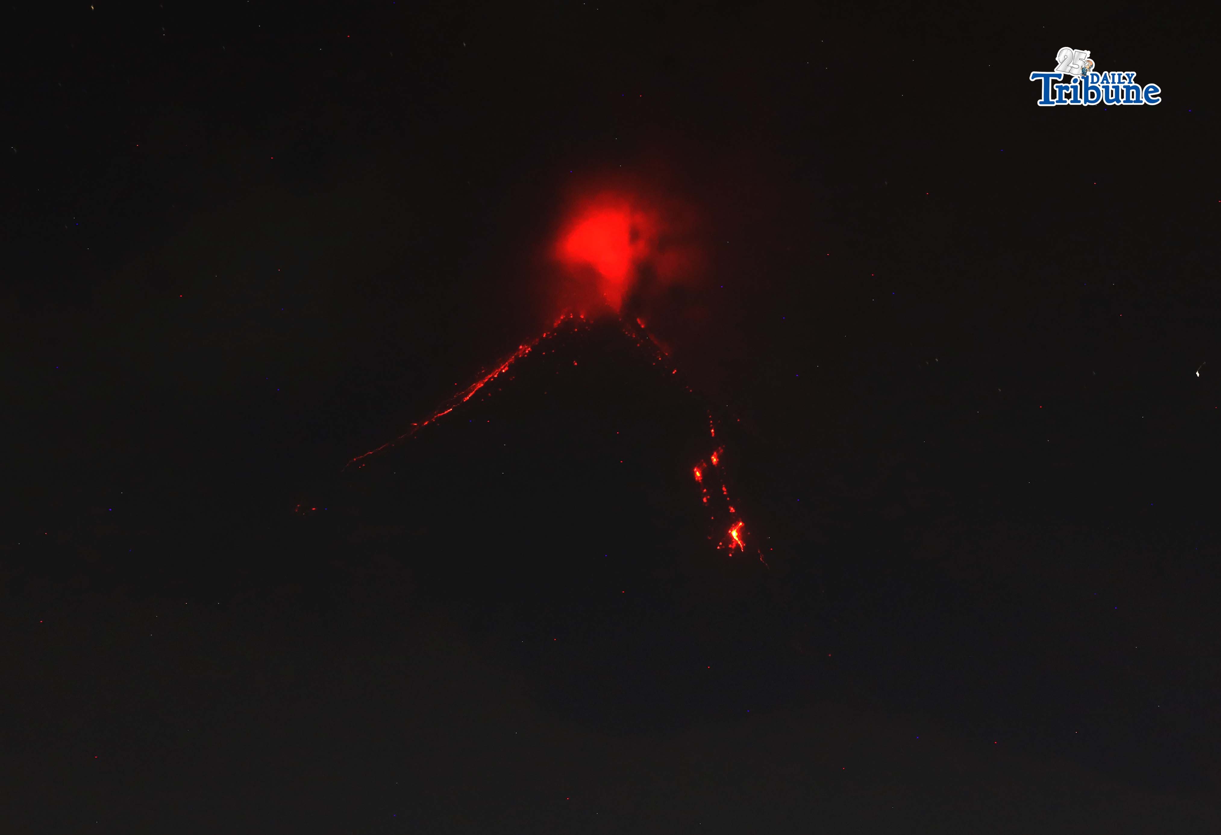 Pyroclastic density currents flow down the slopes of Mayon Volcano as seen from Legazpi City on Sunday night, 18 January 2026.