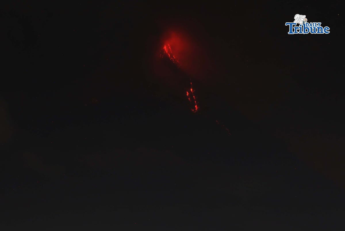 Pyroclastic density currents flow down the slopes of Mayon Volcano as seen from Legazpi City on Sunday night, 18 January 2026.