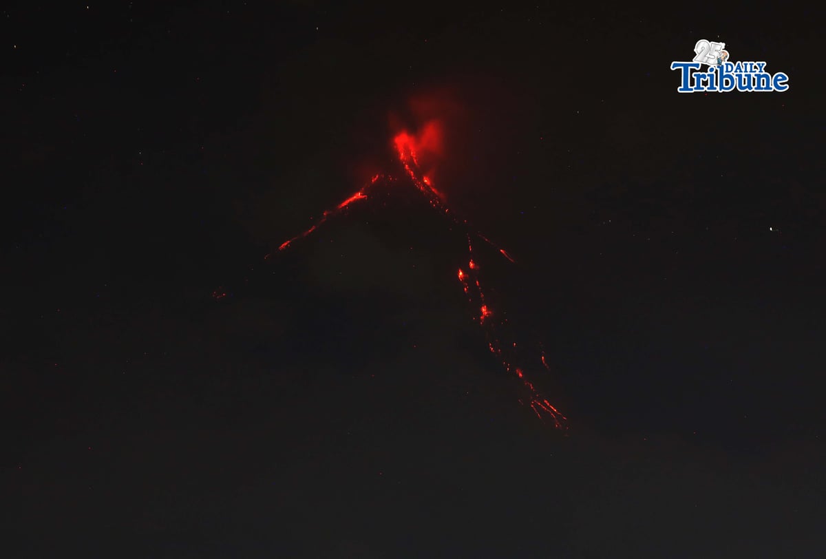 Pyroclastic density currents flow down the slopes of Mayon Volcano as seen from Legazpi City on Sunday night, 18 January 2026.