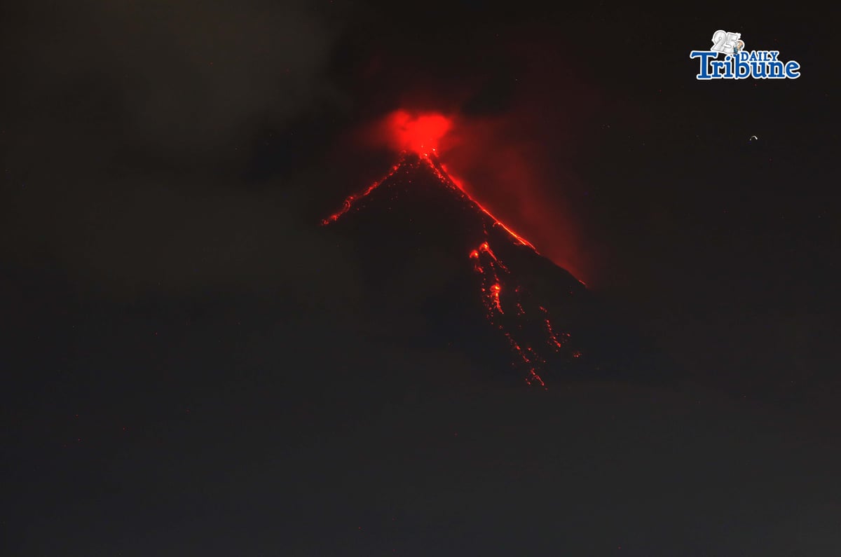Pyroclastic density currents flow down the slopes of Mayon Volcano as seen from Legazpi City on Sunday night, 18 January 2026.
