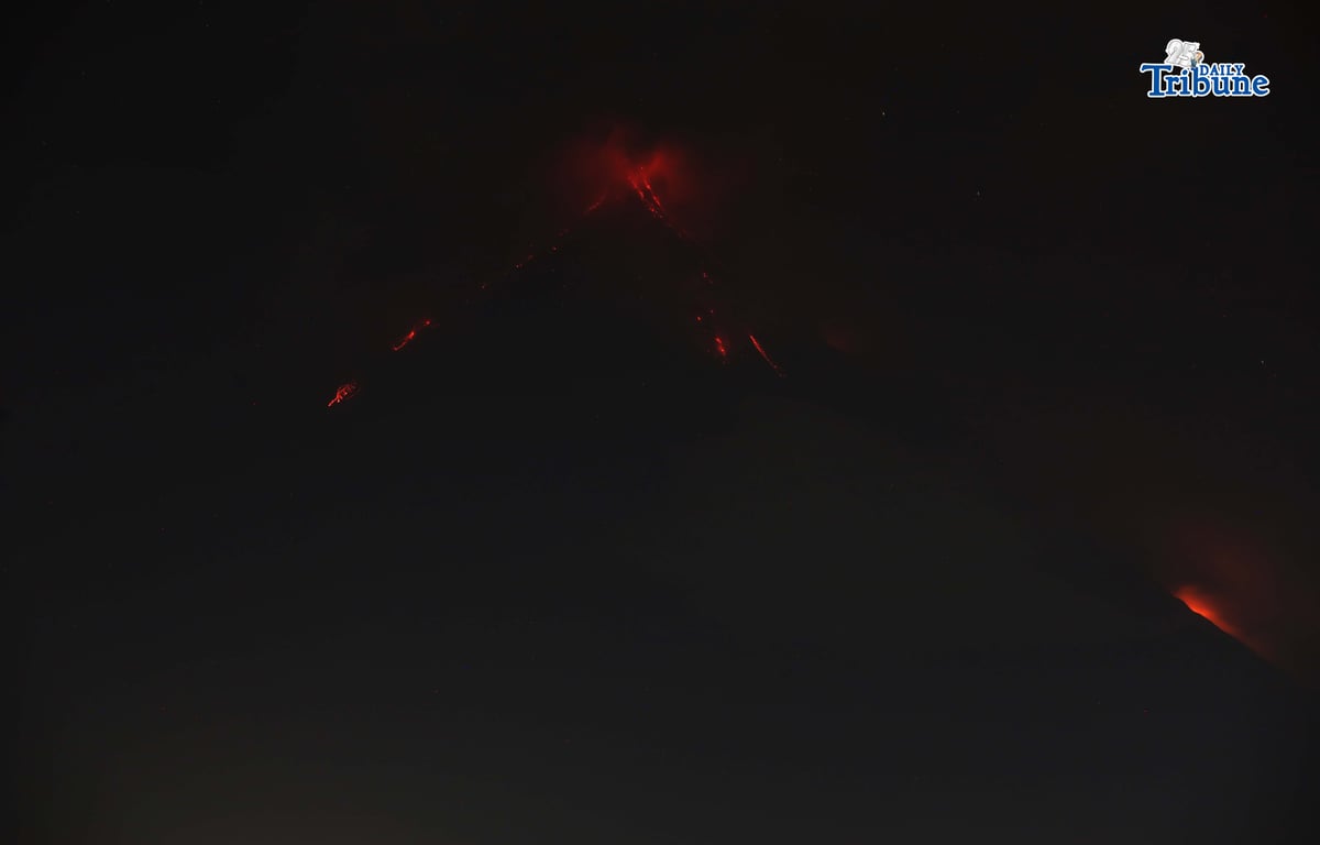 Pyroclastic density currents flow down the slopes of Mayon Volcano as seen from Legazpi City on Sunday night, 18 January 2026.