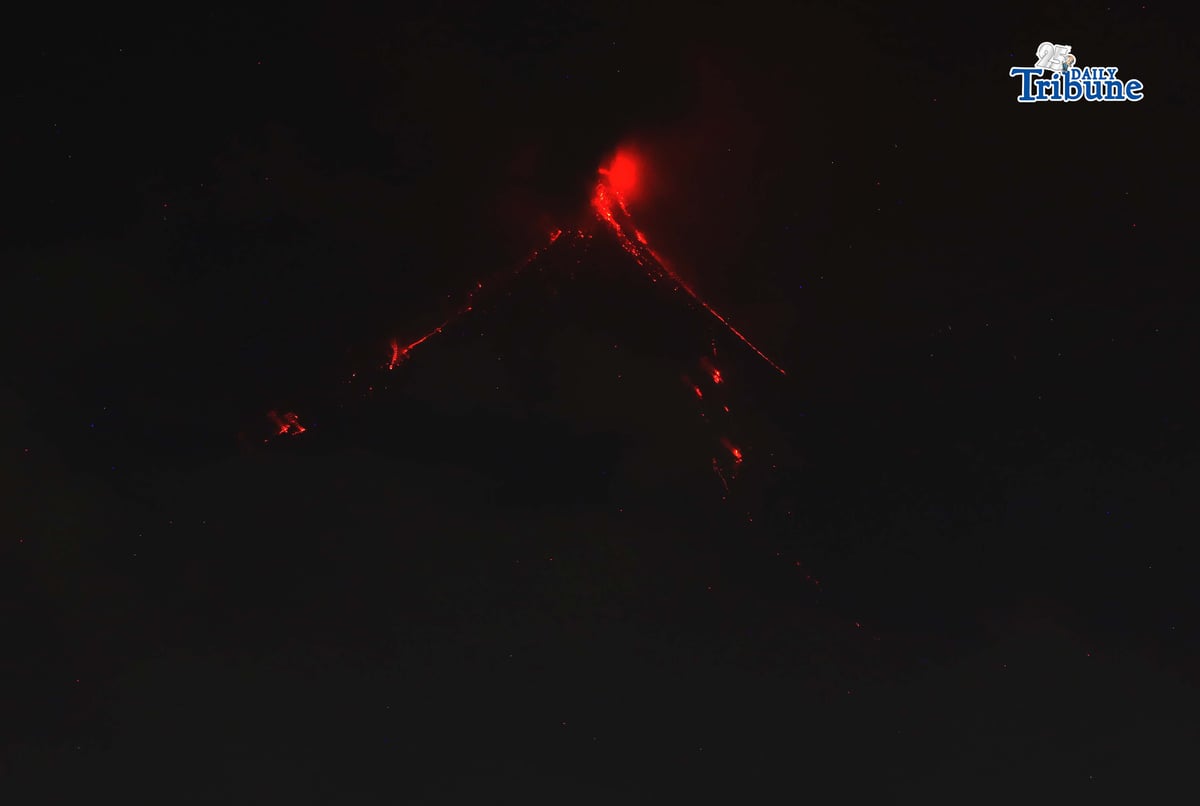 Pyroclastic density currents flow down the slopes of Mayon Volcano as seen from Legazpi City on Sunday night, 18 January 2026.