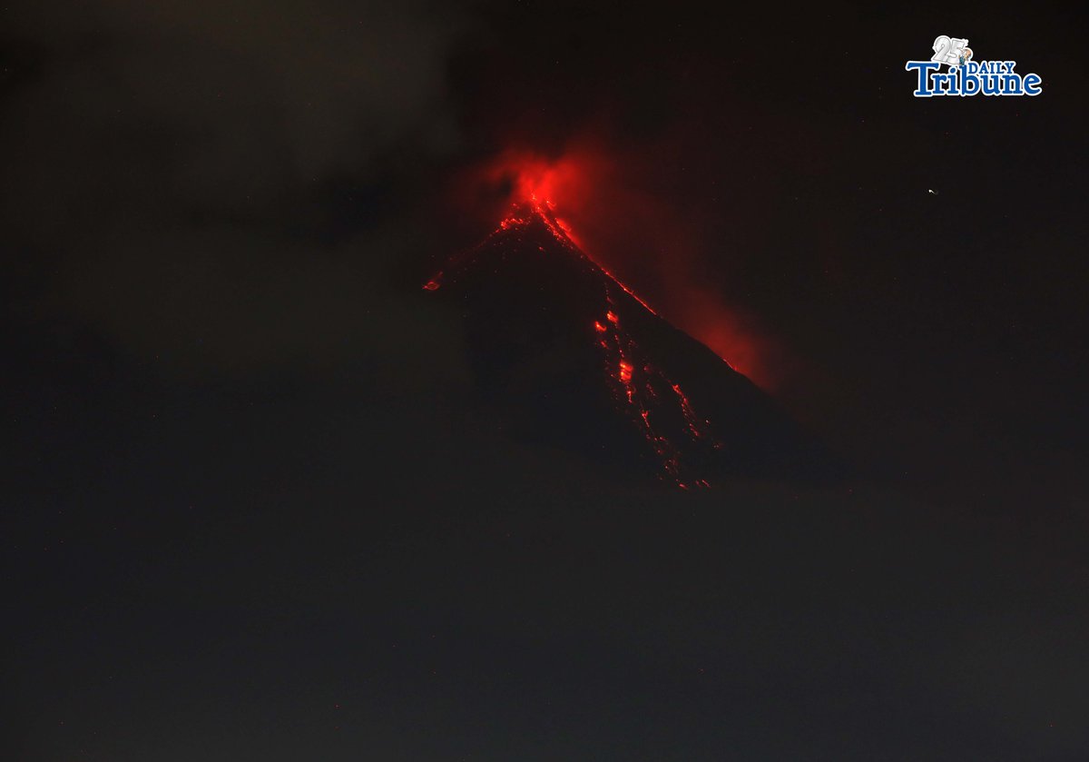 Pyroclastic density currents flow down the slopes of Mayon Volcano as seen from Legazpi City on Sunday night, 18 January 2026.