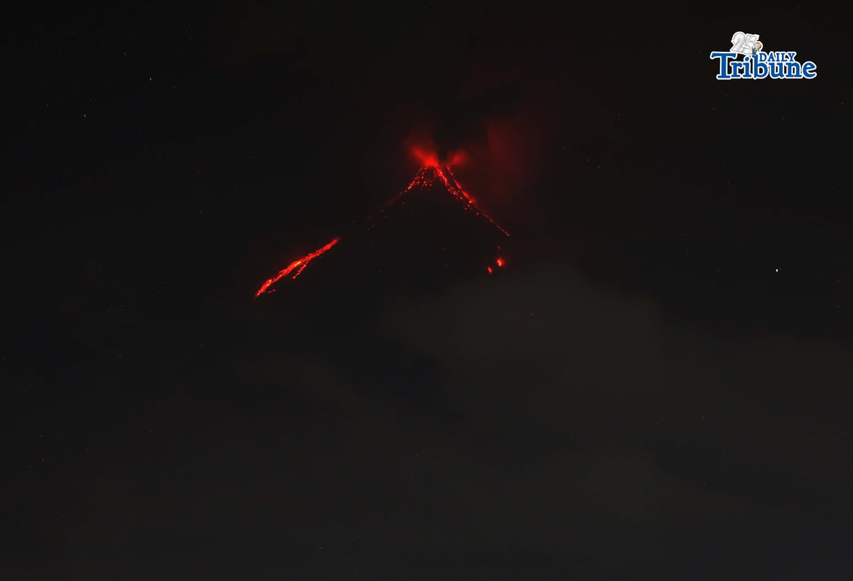 Pyroclastic density currents flow down the slopes of Mayon Volcano as seen from Legazpi City on Sunday night, 18 January 2026.