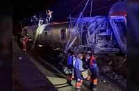RESCUERS search a derailed train coach in Adamuz, Spain.