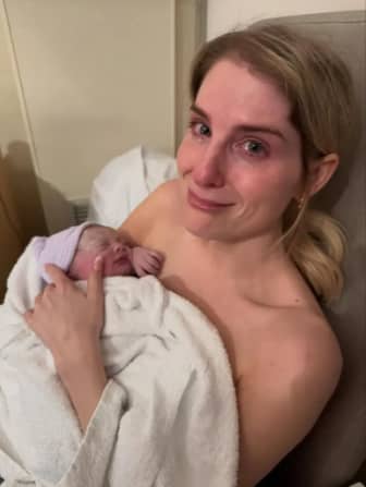 The singer is emotional with the birth of her new baby daughter, thanking their surrogate and calling her a "superwoman."