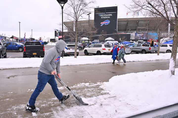 A fan shovels snow before the game between the New York Jets and Buffalo Bills at Highmark Stadium on January 04, 2026 in Orchard Park, New York. Jason