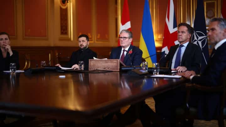 Britain's Prime Minister Keir Starmer (C) flanked by Ukraine's President Volodymyr Zelensky (2L), NATO Secretary-General Mark Rutte (2R), Denmark's Prime Minister Mette Frederiksen (L) and Netherlands Prime Minister Dick Schoof (R) face a screen with other participants joining by video link as he hosts a 'Coalition of the Willing' meeting of international partners on Ukraine at the Foreign, Commonwealth, and Development Office (FCDO) in central London on October 24, 2025. British Prime Minister Keir Starmer told Ukraine's President Volodymyr Zelensky during a meeting in London on Friday that there was more that Western allies could do to bolster Kyiv's long-range missile capability.