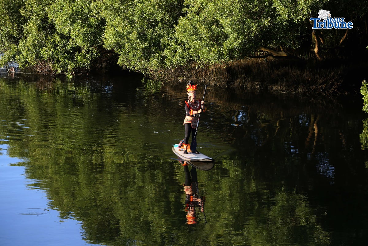 (January 24 2026) Lucy Lynette Ponce Uygongco wearing a Dinagyang warrior costume with her dog is seen paddle along the Iloilo river, at the eve of the Dinagyang festival in Iloilo City on January 24, 2026, in her way to aim promote healthy living and clean river. Photo/Ansly Labor