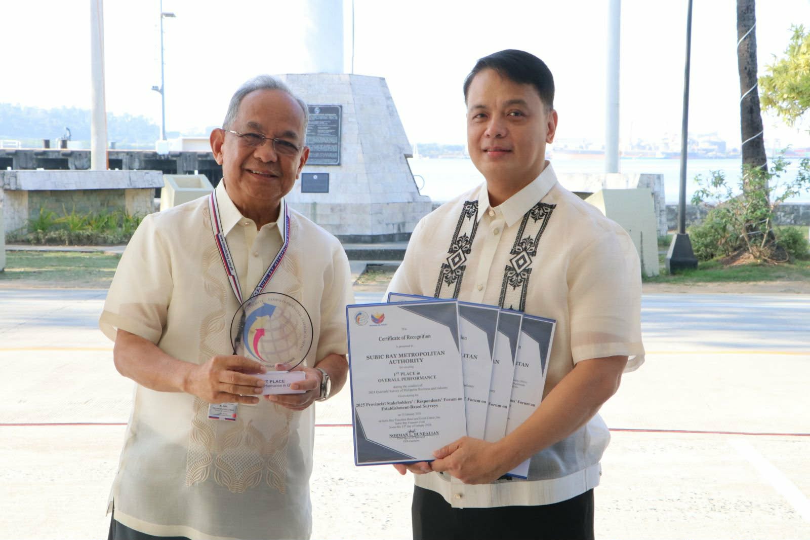 Subic Bay Metropolitan Authority (SBMA) Chairman and Administrator Eduardo Jose L. Aliño proudly holds the trophy and several Certificates of Recognition for its performance in the 2024 Quarterly Survey of Philippine Business and Industry with Norman L. Bundalian, Chief Statistical Specialist of the Philippine Statistics Authority (PSA)-Zambales and PSA personnel during the flag ceremony in front of the Administration Building 229 on January 19, 2026.