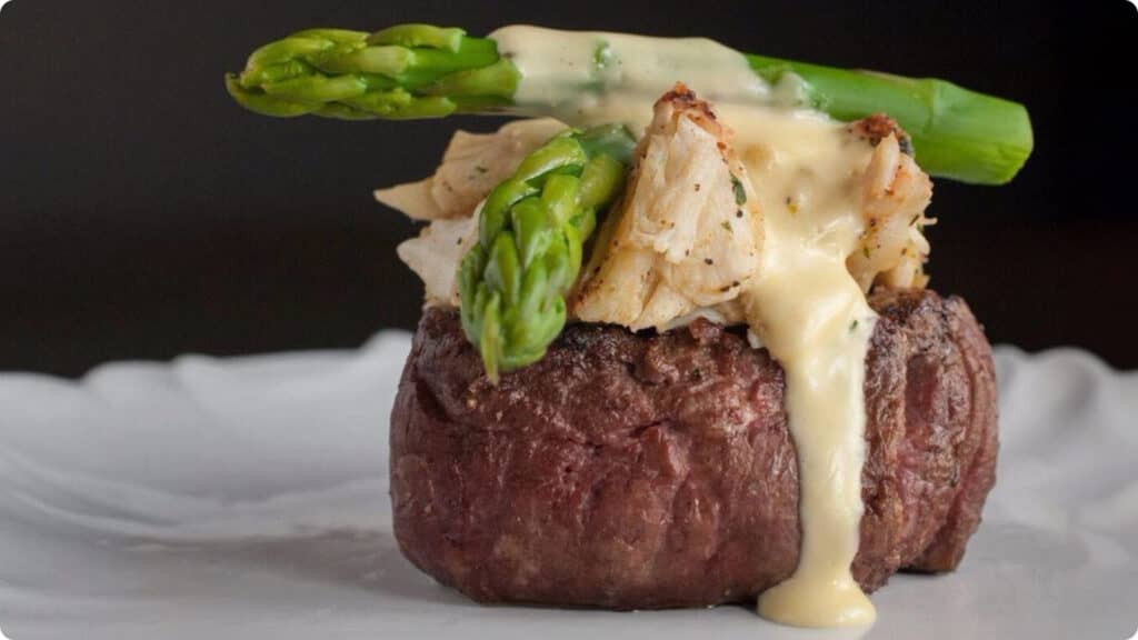 FILET Oscar — center cut filet topped with 2 ounces of jumbo crab cake and Hollandaise sauce.