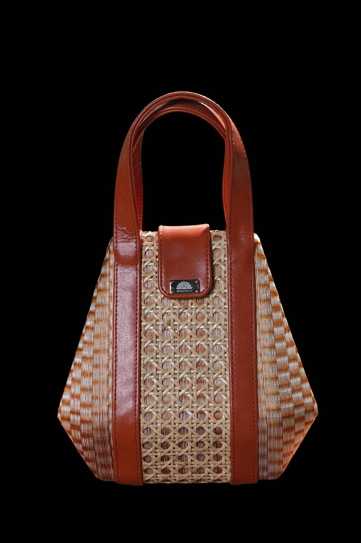 THIS Anmari & Co. Hand Bag from the Buntal and Solihiya collection utilizes native buntal fiber and solihiya sourced from Quezon province and hand woven by local weavers in Marinduque. This is hand crafted into bags by highly skilled crafts men and women from Bulacan. The major inspiration of the collection is to showcase the unique buntal fiber weave taken from the leaves of the buri palm. Modern design meets heritage craftsmanship. These bags are spacious, functional without compromising artisanal roots, a perfect companion for every occasion. The dimension is 23 cm length x 12 cm width x 22 cm height.