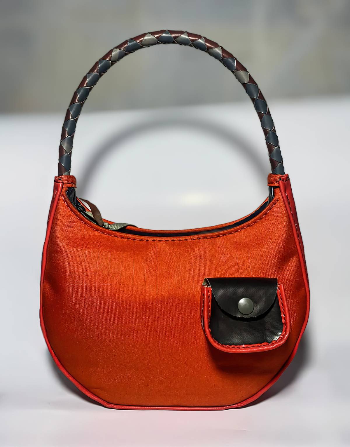 QILI is Project Nova’s bag for the muse. Upcycled from limited-edition inflatable kayaks that come in vermillion red or shadow grey and available while the source material lasts. The braided handle adjusts from hand carry to shoulder bag with front mini detachable pocket. And for adornment is a snap-off dimensional flower. Dimension is Height 30.7cm — 39.1cm, Length: 24.5cm Width: 5.9cm.