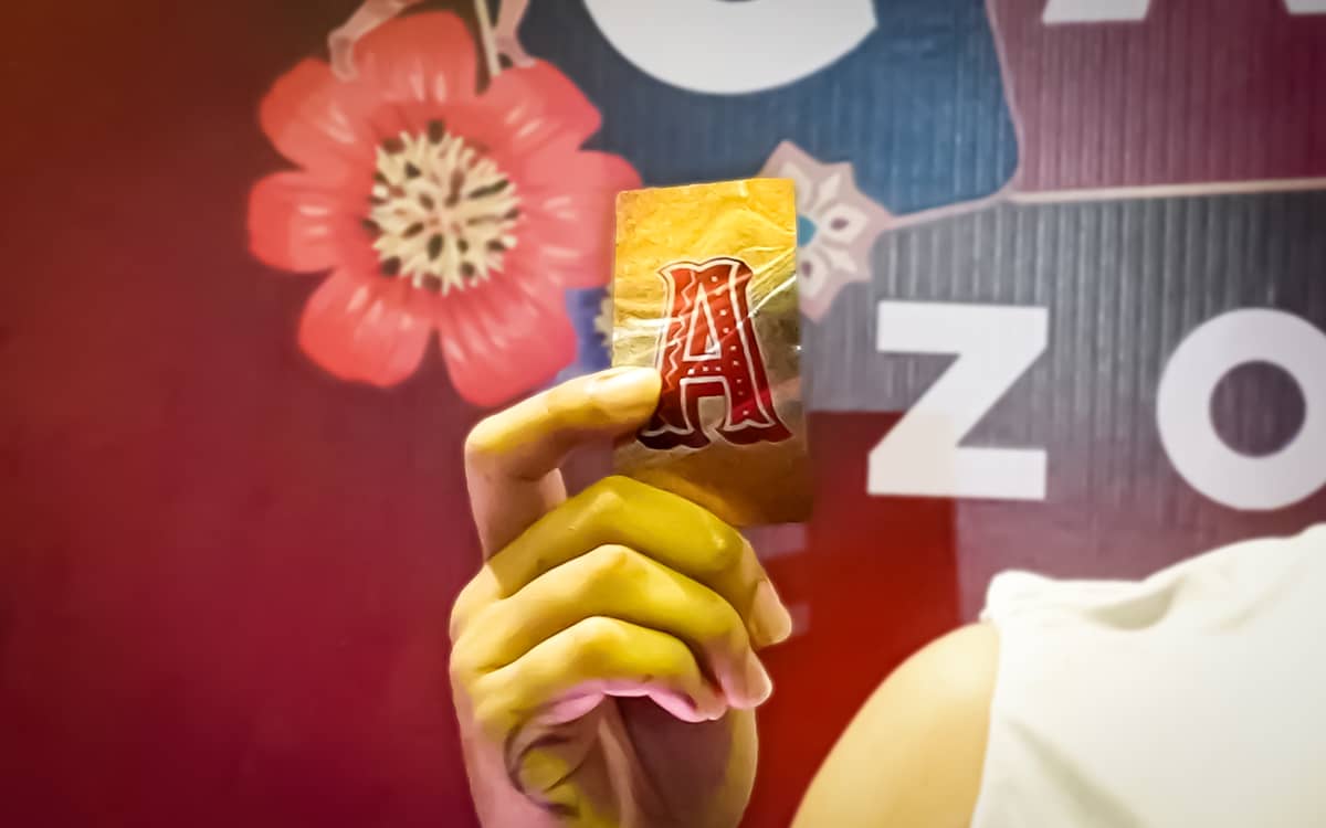 A lucky participant proudly holds a winning gold card.