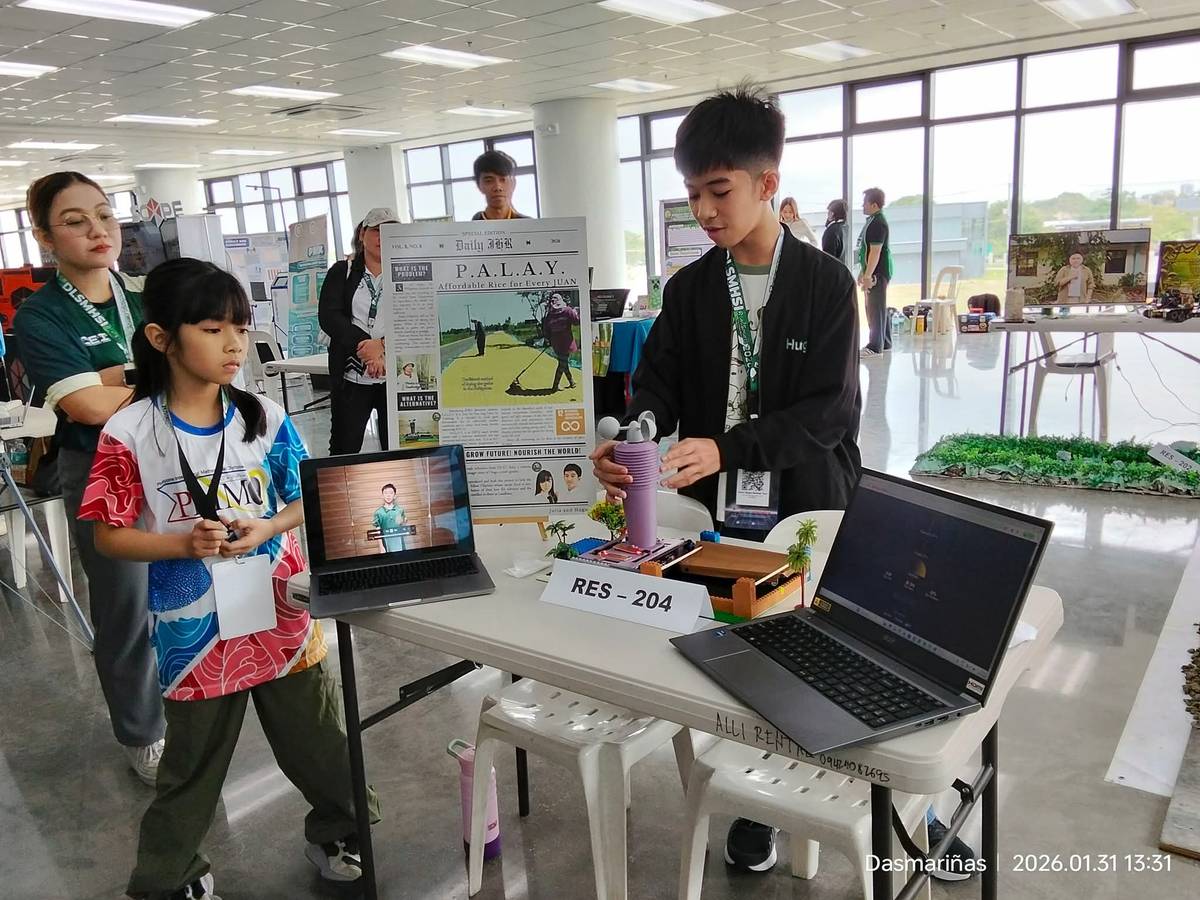 Hugo and Julia Tan, a brother-sister team from De La Salle Zobel, present a mini prototype of their ESP32-based weather system designed to help rice farmers.