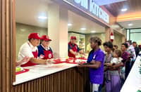 Presidential Adviser on Poverty Alleviation, Larry Gadon, assists in handing out meals for families at the DSWD's first food bank at the Nadaske Building in Pasay City