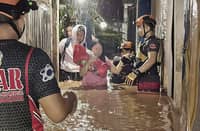 MEMBERS of the local government’s rescue team guide residents out of their flooded homes in Barangay Bugo as tropical storm ‘Basyang’ continues its onslaught in Mindanao.