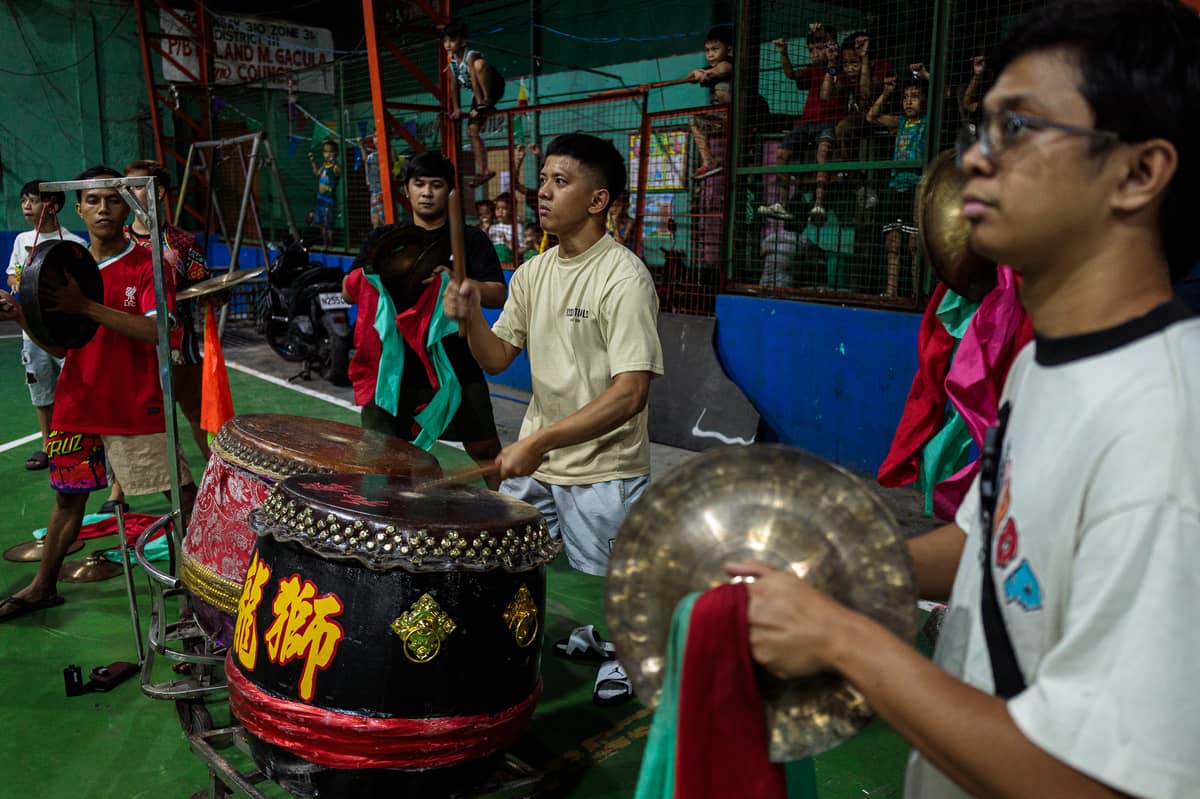 Drummers play during a practice session. They are referred to as the heartbeat of the lion by setting the pace, rhythm, and mood of the performance.