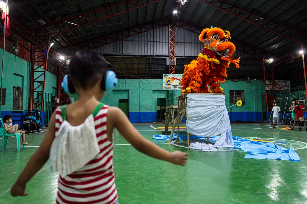Jhayvee Sicat's son mimics his father’s movements during a practice in downtown Manila on Friday, 6 February 2026.