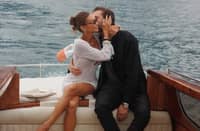 EMIL kisses Kylie’s cheek as she proudly displays her engagement ring.