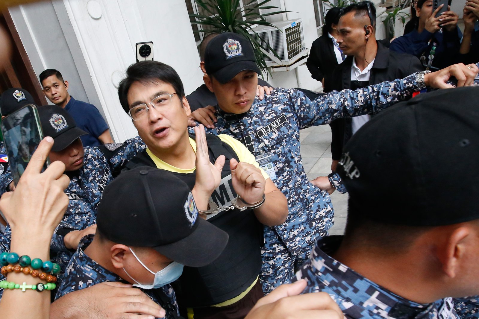 Former Senator Ramon Bong Revilla Jr. leaves the Department of Justice in Manila on Thursday, 12 February 2026, following a preliminary probe into plunder allegations involving anomalous flood control projects.