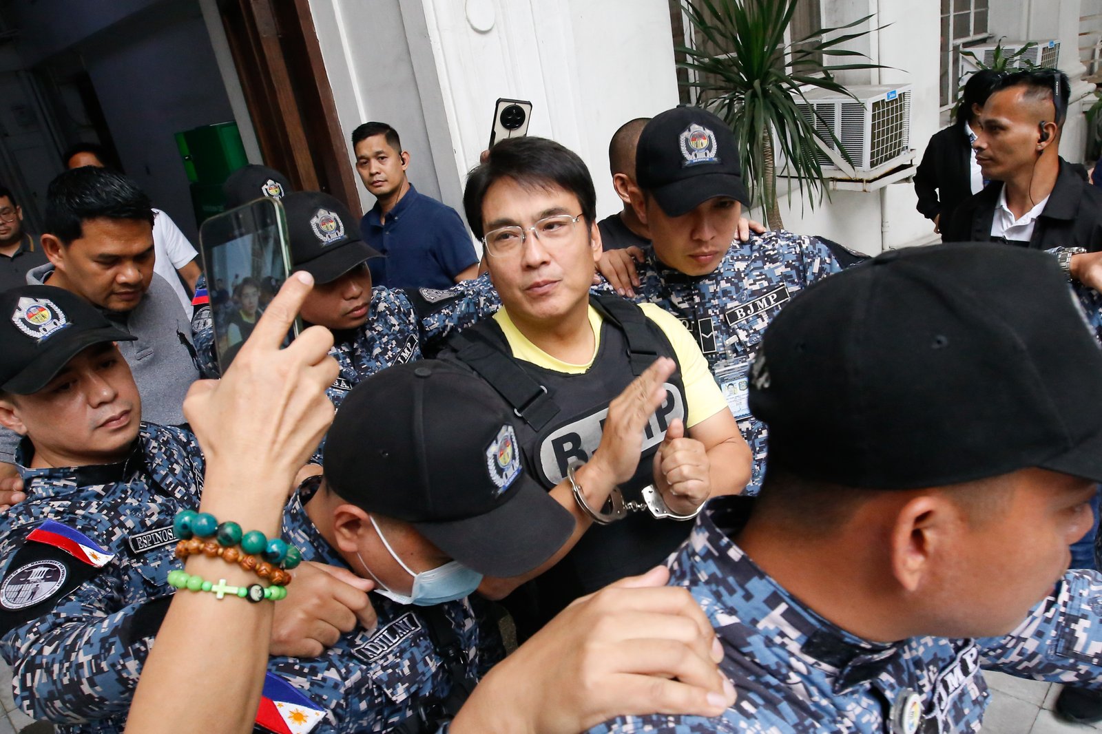 Former Senator Ramon Bong Revilla Jr. leaves the Department of Justice in Manila on Thursday, 12 February 2026, following a preliminary probe into plunder allegations involving anomalous flood control projects.