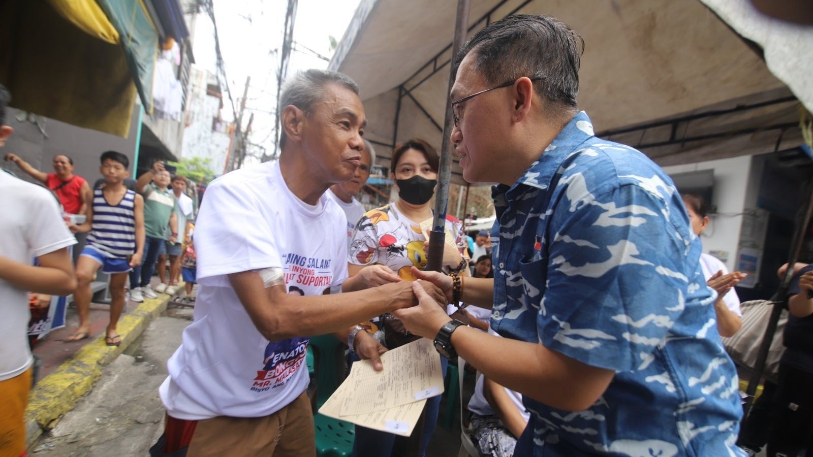 Go visits fire-hit barangay in Sampaloc, assures aid for affected families