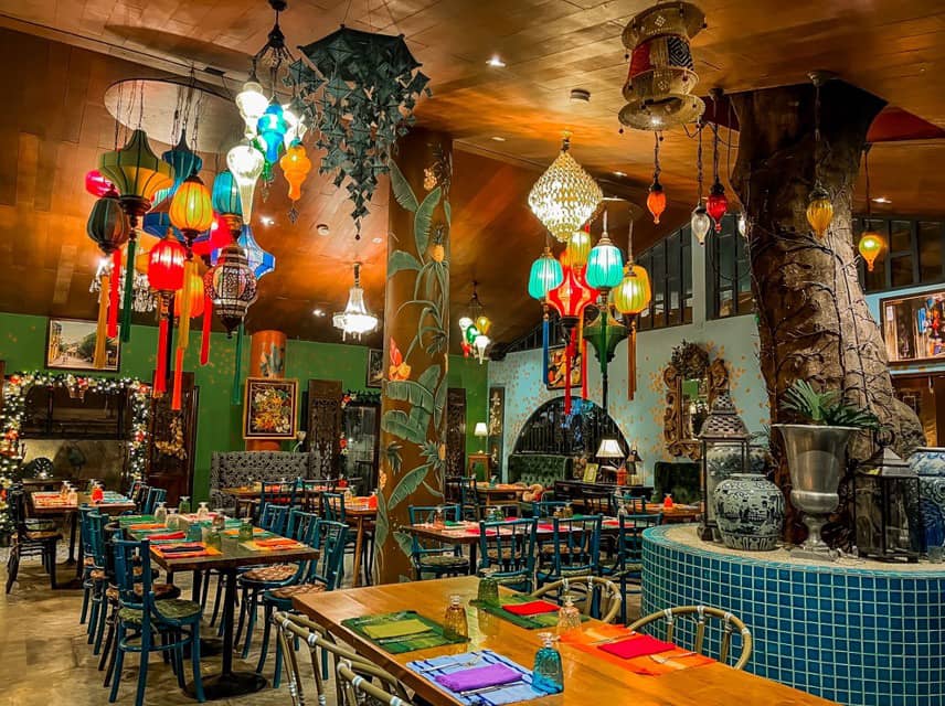 WOODEN walls in olive green and brown, accented with touches of orange and blue with intricate tropical designs, creating a vibrant atmosphere