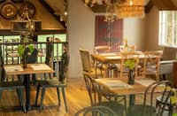 INSIDE NAPA, the inviting interior features wooden accents, softly glowing chandeliers, barrels, and wall decorations that perfectly complement the restaurant’s vibe, setting that romantic mood.