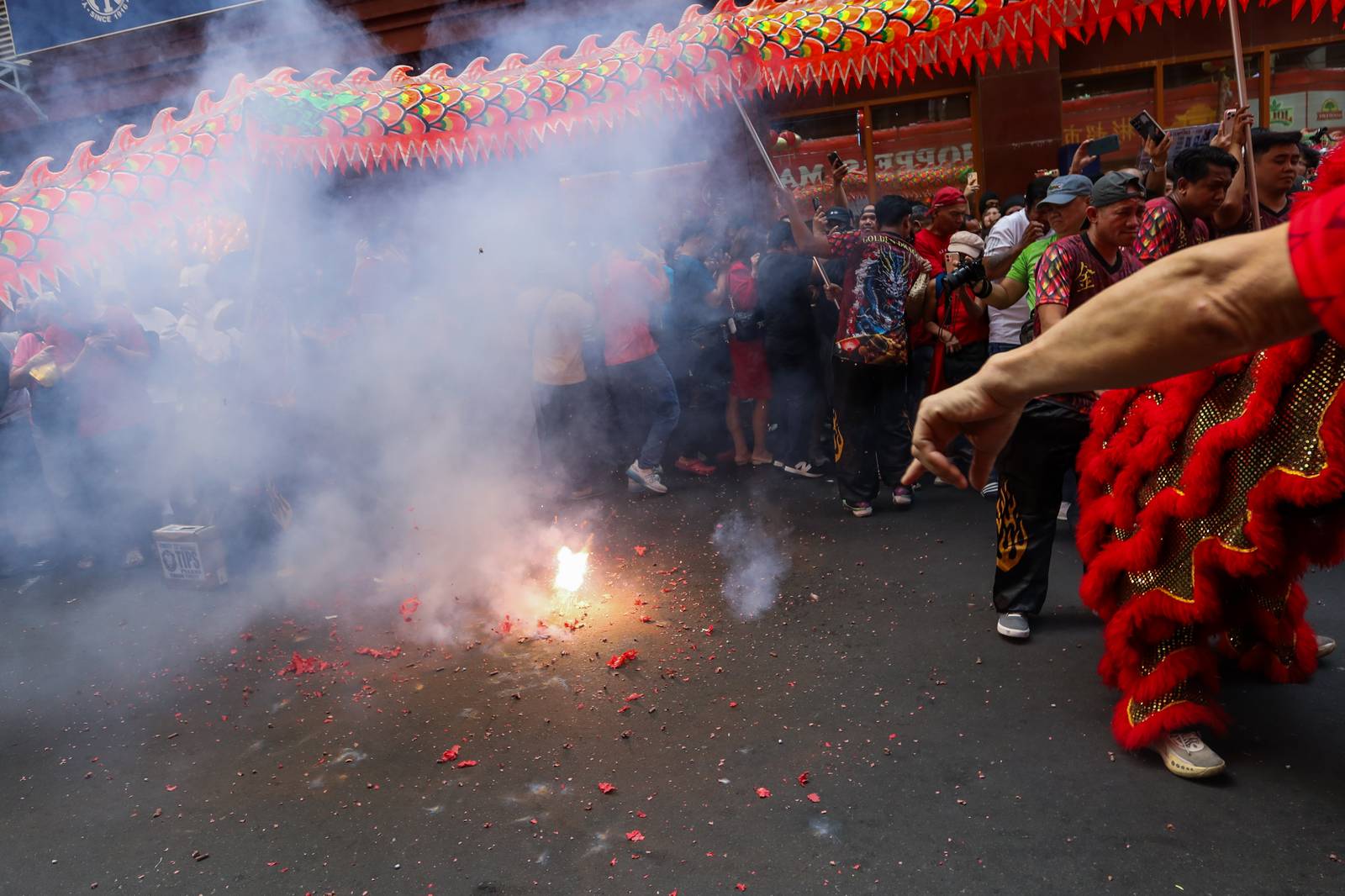 Dragon dancers are seen amid crackling fireworks outside a local supermarket in Chinatown, Binondo, Manila, in celebration of the Lunar New Year on Tuesday, 17 February 2026.| Aram Lascano/DAILY TRIBUNE