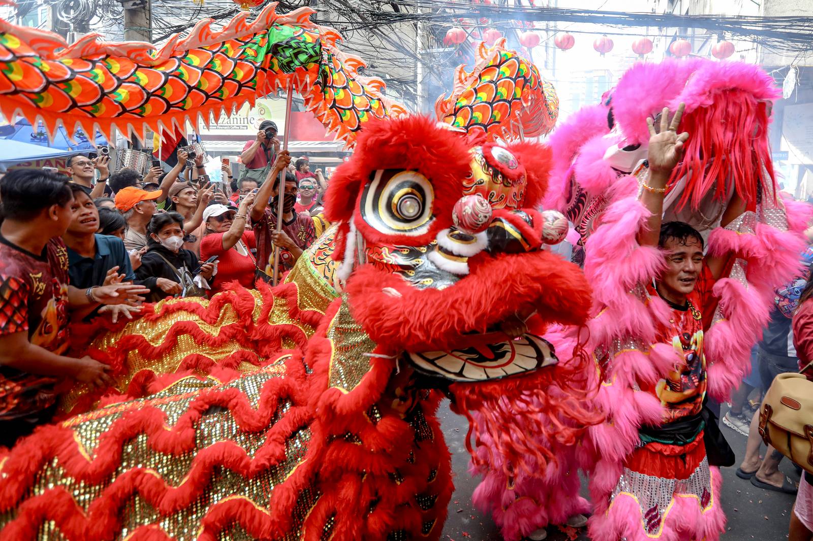 Dragon dancers are seen amid crackling fireworks outside a local supermarket in Chinatown, Binondo, Manila, in celebration of the Lunar New Year on Tuesday, 17 February 2026.| Aram Lascano/DAILY TRIBUNE