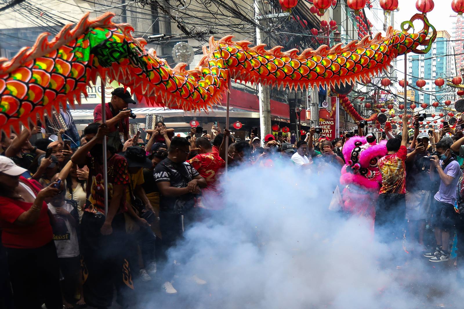 Dragon dancers are seen amid crackling fireworks outside a local supermarket in Chinatown, Binondo, Manila, in celebration of the Lunar New Year on Tuesday, 17 February 2026.| Aram Lascano/DAILY TRIBUNE